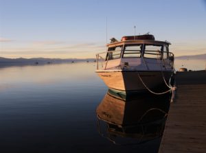 Boat at a dock in Lake Tahoe by Mark Hinte