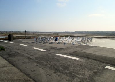 Parking lot at Bolsa Chica set up for speakers and an audience for the 10th anniversary celebration.