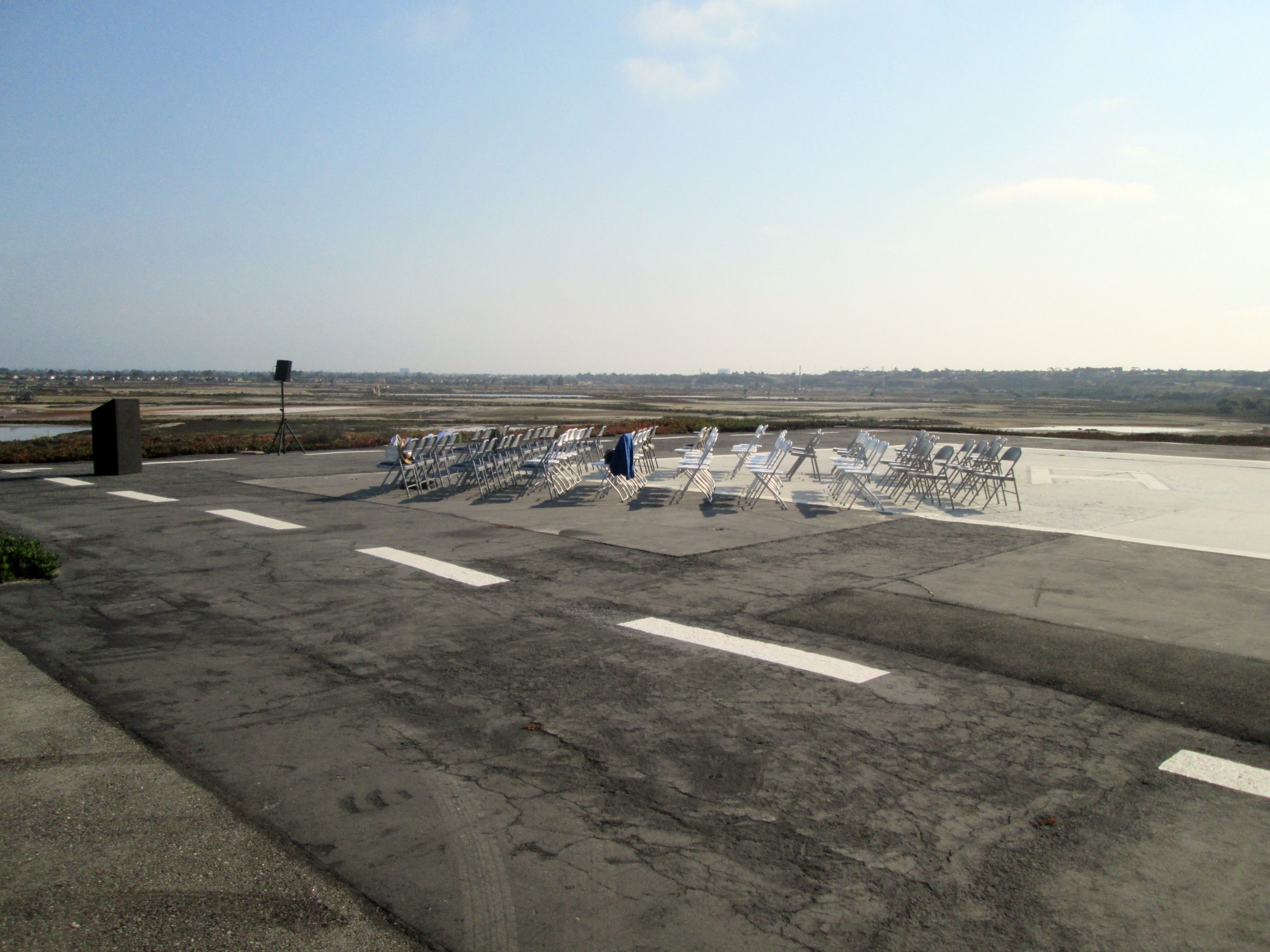Parking lot at Bolsa Chica set up for speakers and an audience for the 10th anniversary celebration.
