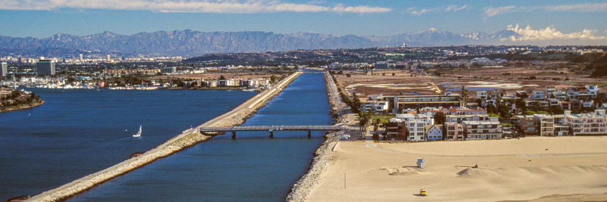 An aerial view looks east toward the Marina del Rey Inlet and Ballona Creek a major boating and water harbor off the Pacific Ocean in the Los Angeles area of Southern California.