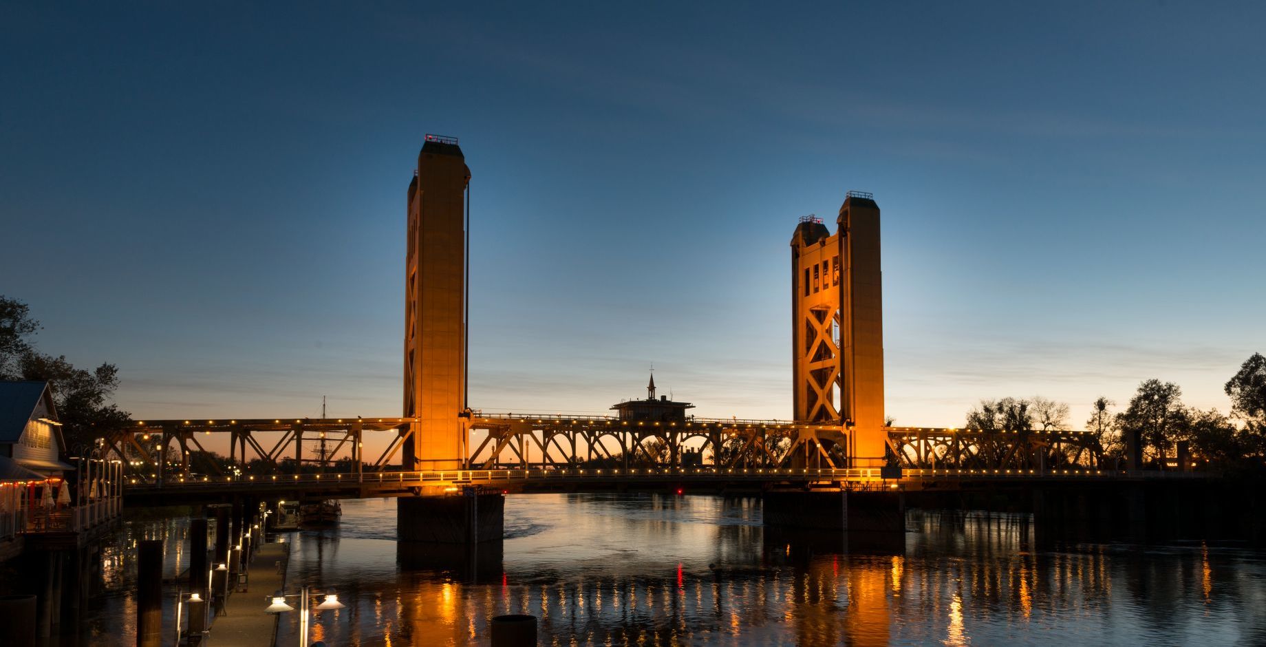 The Tower Bridge is a vertical lift bridge across the Sacramento River, linking West Sacramento in Yolo County to the west, with the capital of California, Sacramento, in Sacramento County to the east