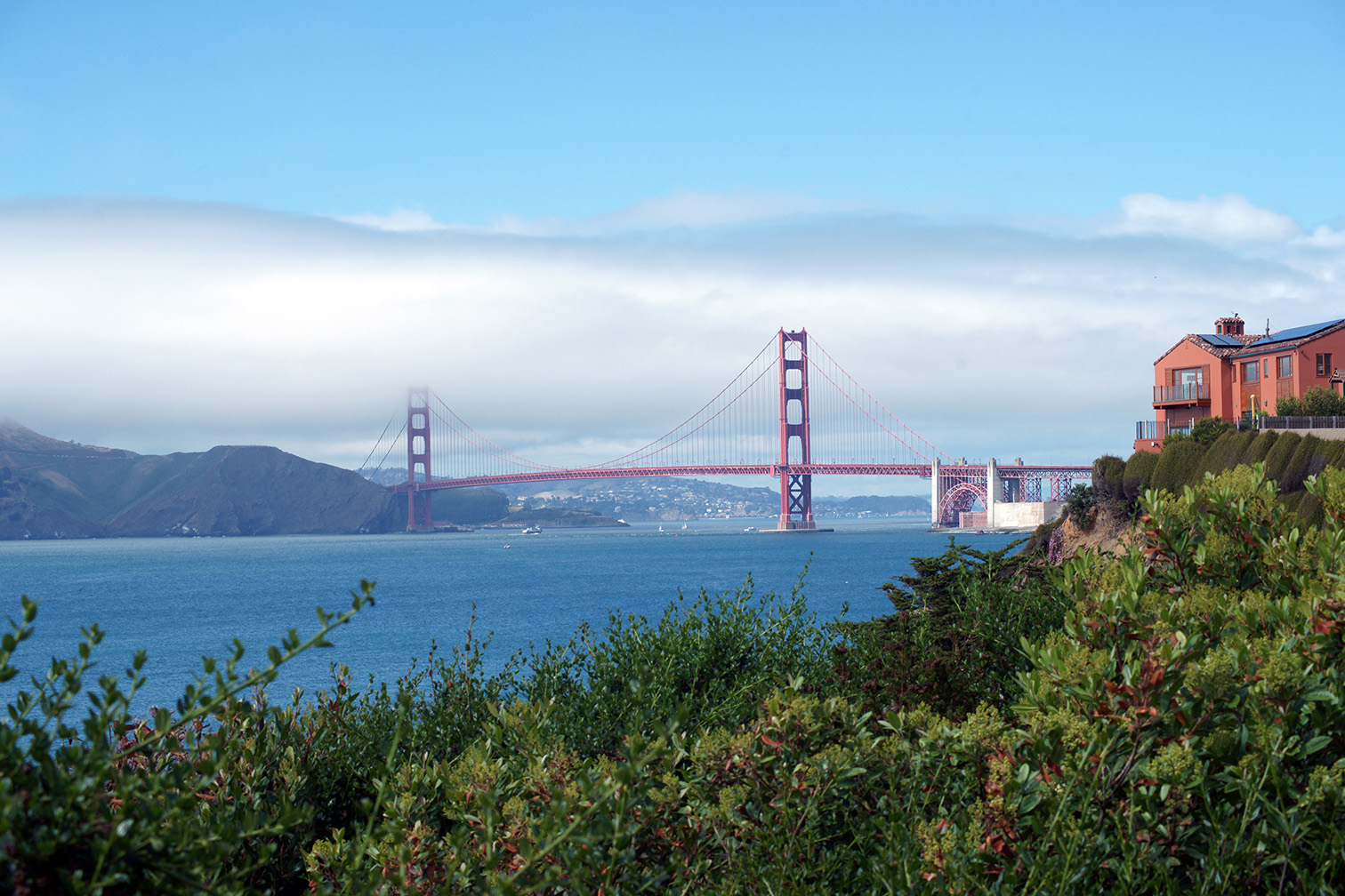 Golden Gate Bridge over the SF bay with fog rolling in