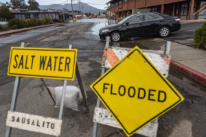 A vehicle is shown after detouring to avoid standing water on Gate 5 Road in Sausalito, CA near high tide as a King Tide’s effect is seen December 15, 2020, elevating the usual high water marks in Marin County. Andrew Innerarity/ California Department of Water Resources