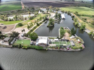 Windmill Cove Marina and Bar and Grill river in the foreground. buildings, cove, marina and rv park inthe background.
