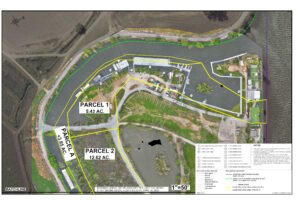 Windmill Cove and the historic bed of the San Joaquin River aerial map 1 of 2 showing lease areas, shoreline, and key site features. Includes labeled parcels, buildings, roads, docks, bulkheads, fence lines, stairs, decks, use areas, and trailer spaces. There are three lease parcels: Parcel 1, consisting approximately 5.43 acres; a portion of Parcel 2, consisting approximately 12.62 acres in total; and Parcel A, consisting approximately 3.85 acres in total. Notable structures within Parcel 1 are restroom/laundry facility, cabins, uncovered and covered boat berths, wooden and aluminum docks, a concrete boat launch, and a wooden pier. There are no structures within Parcel 2. Parcel A consists of a small portion of the wooden pier, with most of the wooden pier contained in Parcel 1.Lease boundaries and shoreline are outlined, with notes indicating the preliminary nature of the plat and referencing official records and surveys. The base map is an aerial orthophoto from a Commission drone flight dated April 18, 2025.