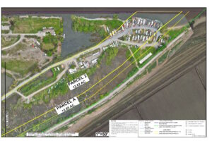 Windmill Cove and the historic bed of the San Joaquin River aerial map 2 of 2 showing lease areas, shoreline, and site features. There are two lease parcels shown, Parcel 2, consisting approximately 12.62 acres in total, and Parcel A, consisting approximately 3.85 acres in total. Notable structures within Parcel 2 are storage buildings, water facility, three rows of trailer spaces (waterward, middle, landward), gravel roads, docks, bulkheads, fence lines, stairs, decks and use areas. Lease boundaries are outlined, with notes indicating the preliminary nature of the plat and referencing official records and surveys. The base map is an aerial orthophoto from a CSLC drone flight dated April 18, 2025.